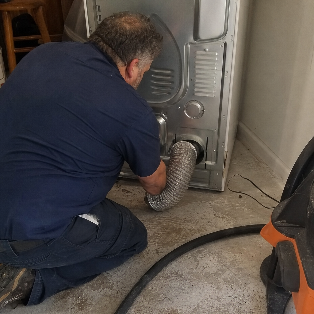 Professional technician performing residential dryer vent cleaning service